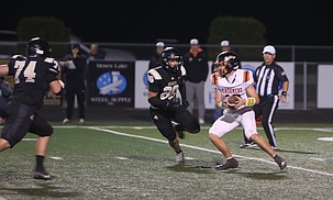 The Knights’ Orlando Santillan (74) and Tyce Christensen (80) get after the Cashmere quarterback during their matchup earlier this season. Royal is set to face Cashmere again, this time in the 1A state championship game.