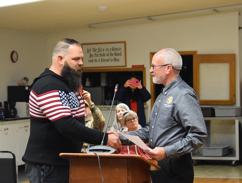 Mayor Peter Sharp, left, completes his oath of office with Grant County Commissioner Kevin Burgess, right, at the Wednesday meeting. Sharp will serve a two-year unexpired term.