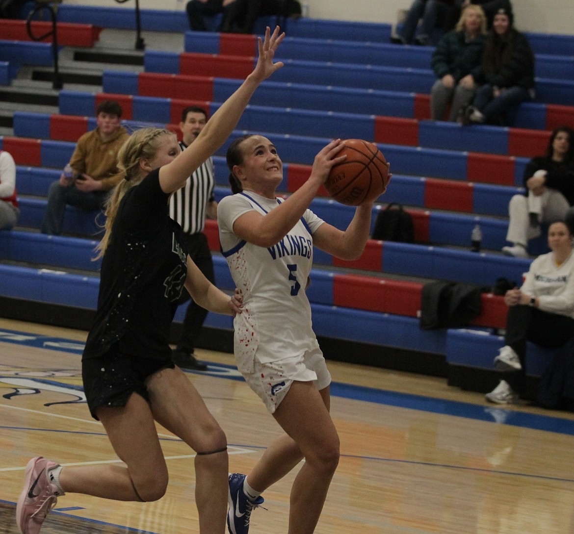 JASON ELLIOTT/Press
Coeur d'Alene guard Kyndal Bridge goes up for a shot as Eagle forward Nicole DeVries defends during the fourth quarter of Thursday's game at Viking Court.