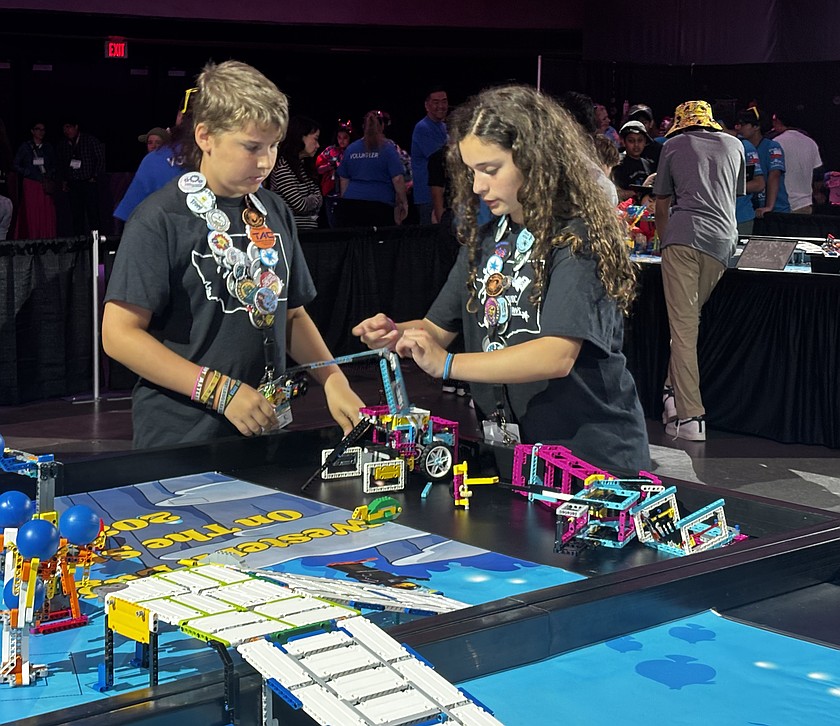 Caleb Freeman, left, and Maria Gallegos, right, of the Royal Middle School robotics team in competition last spring. Middle school robotics is among the activities funded through the school’s educational programs and operations levy.