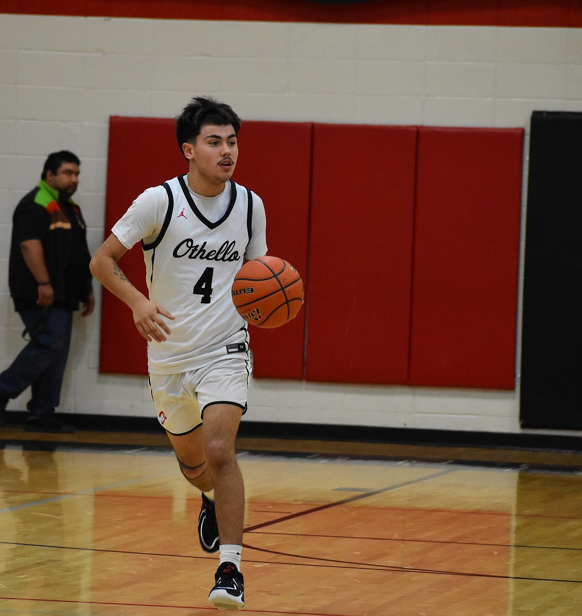 Othello senior Syrus Peppinger moves down toward the hoop after gaining possession of the ball.