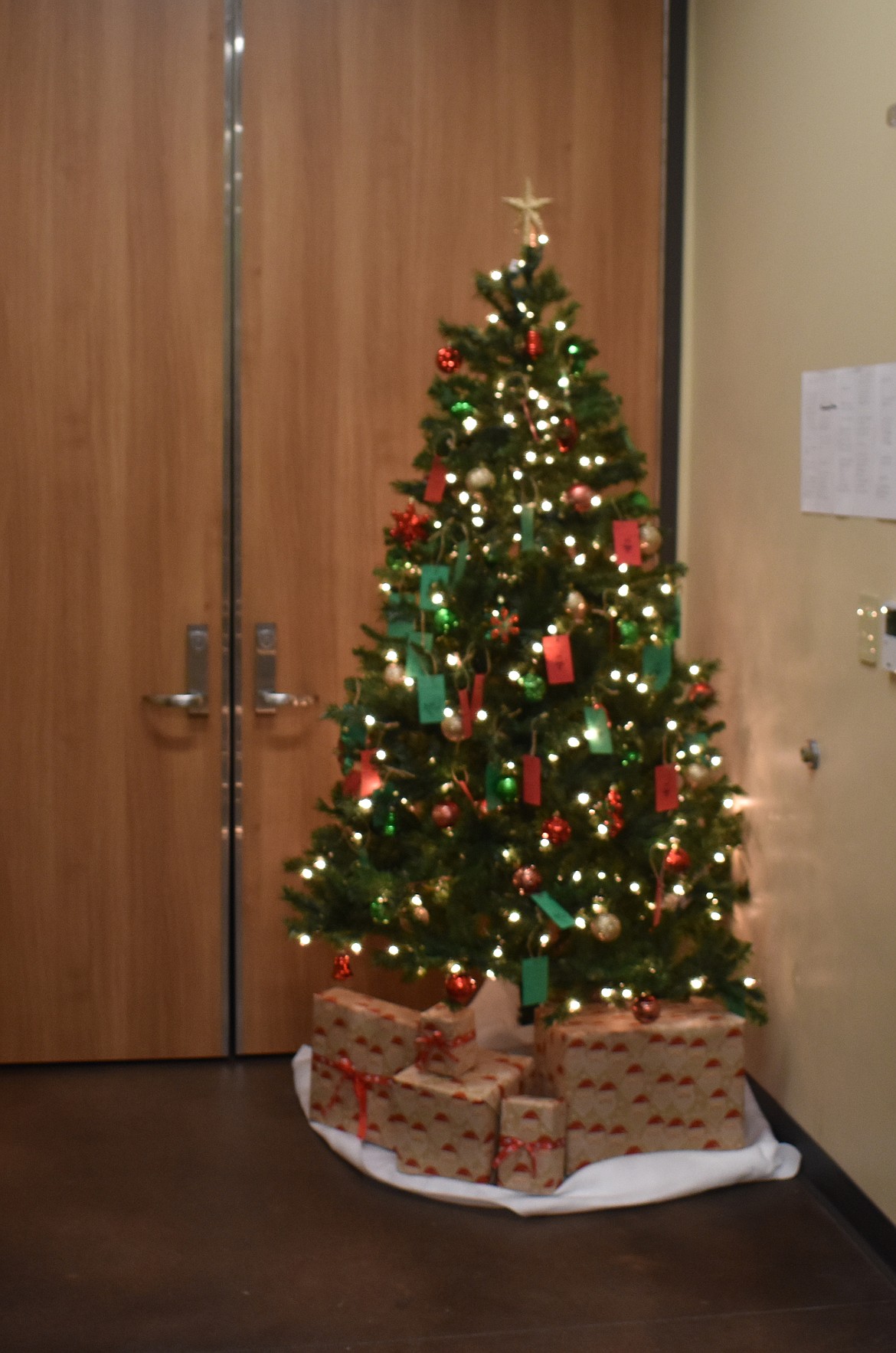 The Moses Lake School District Transportation Department Tree of Sharing stands in the transportation building at 940 E. Yonezawa. As of Friday, there were 18 presents still to be bought for children in the district.
