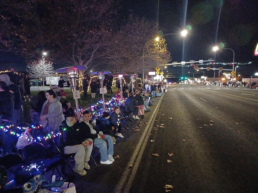 Othello residents wait for the annual holiday parade on a mild, and only slightly windy, night. Periods of rain are forecast early this week.