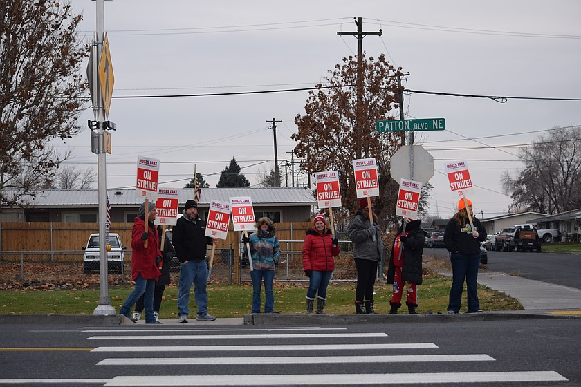 Larson Heights Elementary School teachers walk through the area around the school Dec. 1 during the first day of a strike against the Moses Lake School District. The two sides reached a tentative agreement Friday.