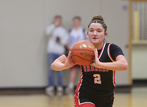 The Broncos’ Saige Galbreath (2) passes the ball off to a teammate during their game against Warden. They defeated the Cougars 58-45 on the road to earn their first win of the 2025 season.