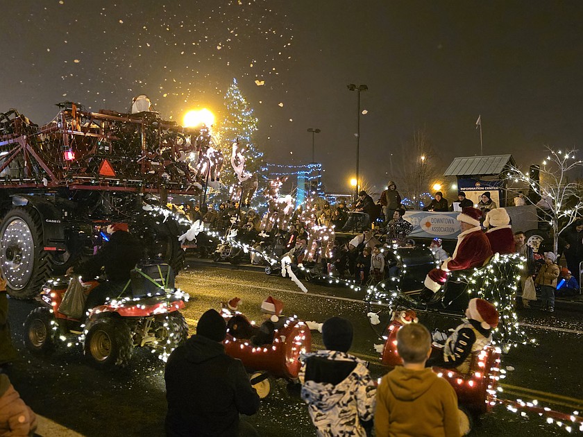 Santa and Mrs. Claus ride in a truck-drawn sleigh at the Downtown Ag Appreciation Parade Friday.