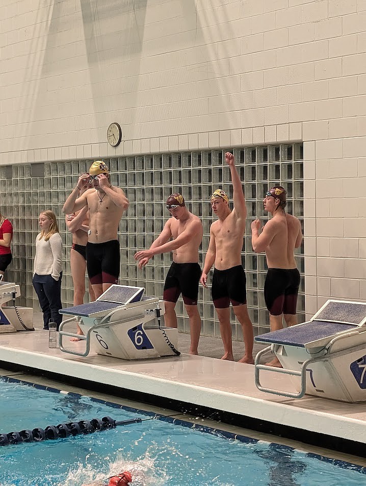 Mavs swimmers Josiah Wallace, Matt Molitor, Sam Molitor and Luke Molitor line up before a relay race at the state swim meet. Josiah Wallace and Sam Molitor are returning as seniors this season and Matt Molitor is returning as a junior.