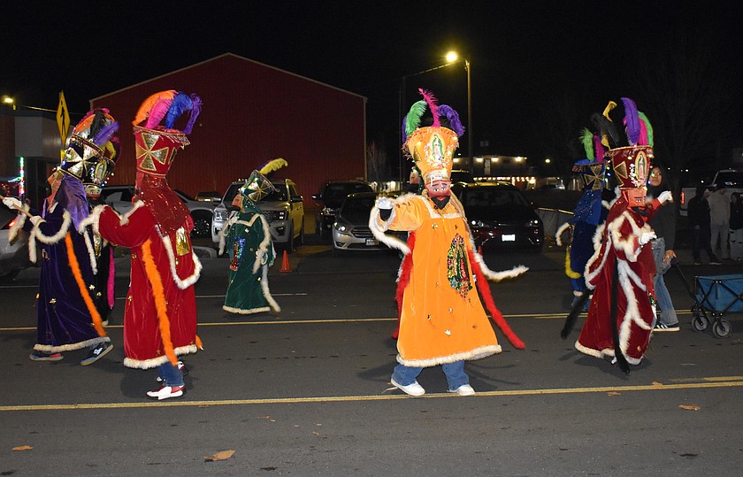 Dancers dressed as the Three Kings perform behind Sacred Heart Catholic Church’s float in the Miracle on Main Street parade Saturday.