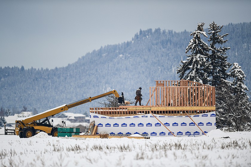 A builder works on a home along Farm to Market Road on Wednesday, Dec. 3. (Casey Kreider/Daily Inter Lake)