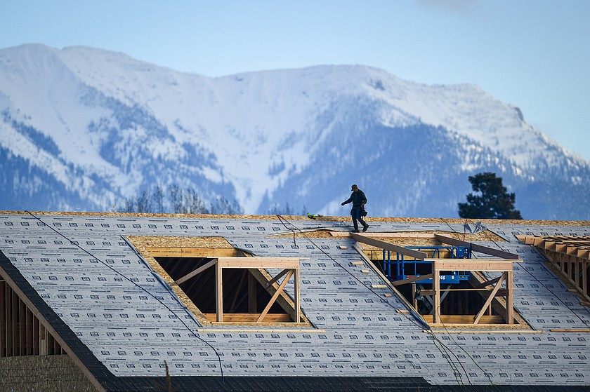 A roofing crew works on a home under construction along Wagner Lane. (Casey Kreider/Daily Inter Lake)