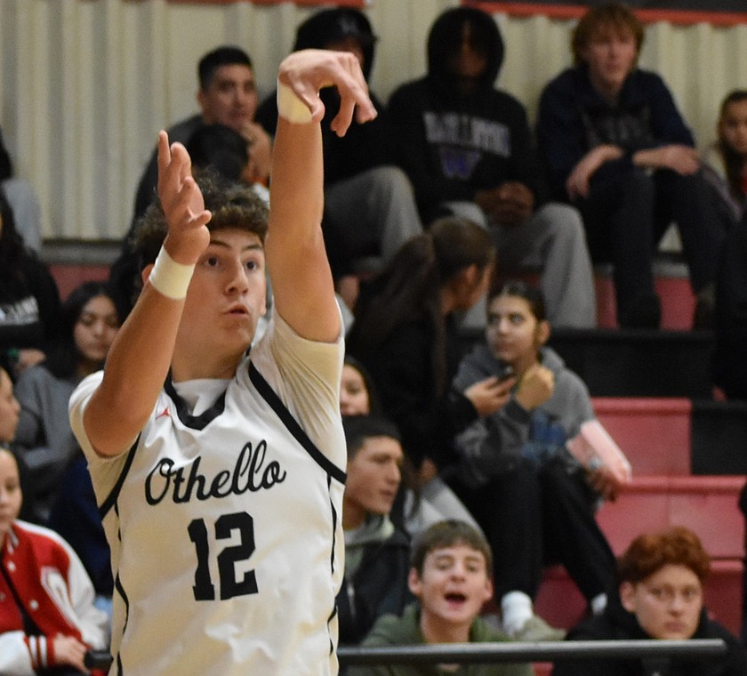 Gavin Simmons, a junior from the Huskies, shoots from the three-point mark during Tuesday’s game against Sageview.