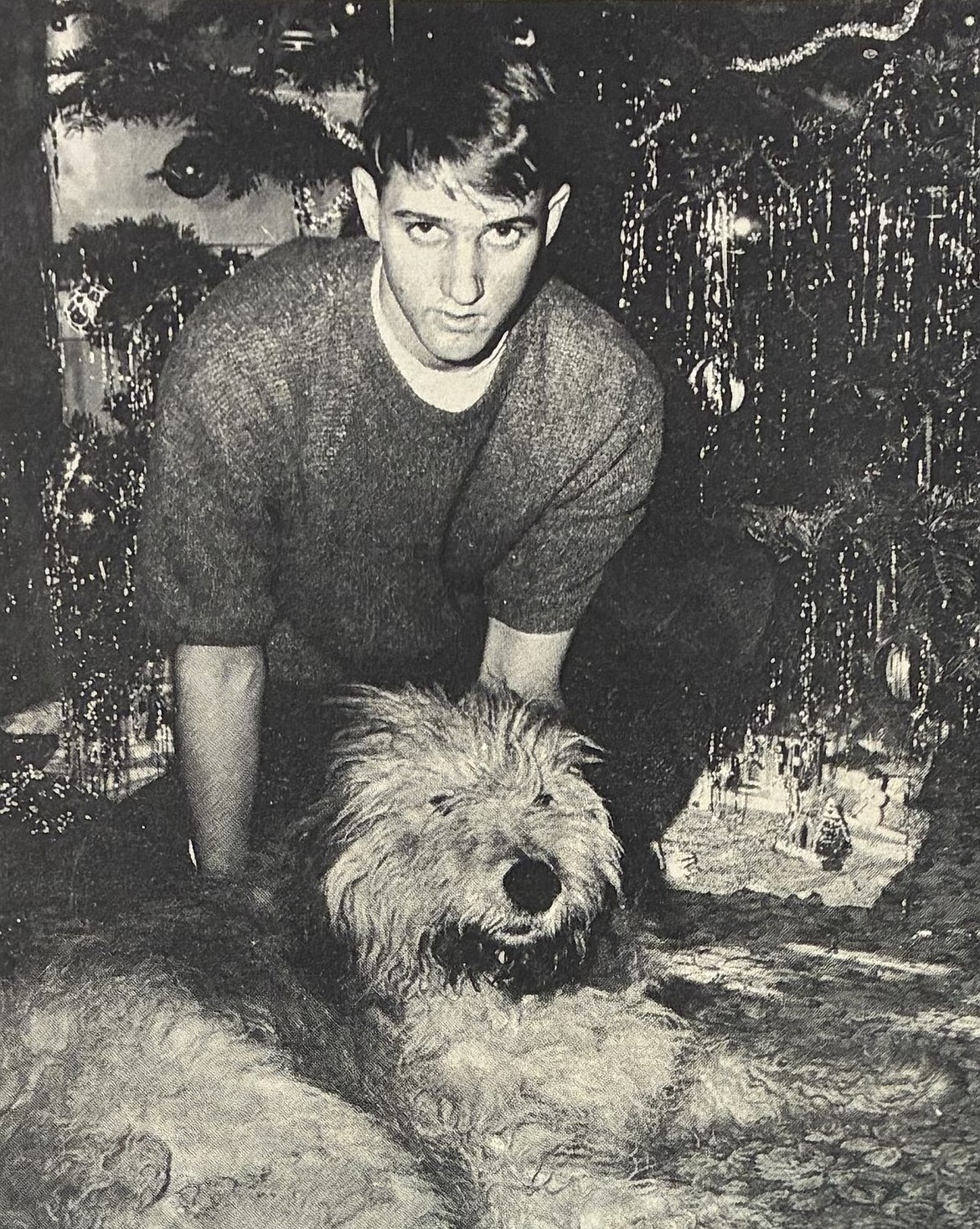Sheepdog Buster poses at his new Rathdrum home with George Greenfield, son of Chief Warrant Officer and Mrs. William Greenfield, in 1965.