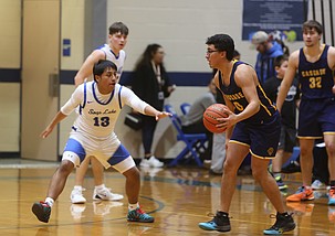 The Eagles’ Lenny Campos (13) presses a Cascade Christian Academy player on defense. The Eagles fell short to the Wolverines 57-37 at home.