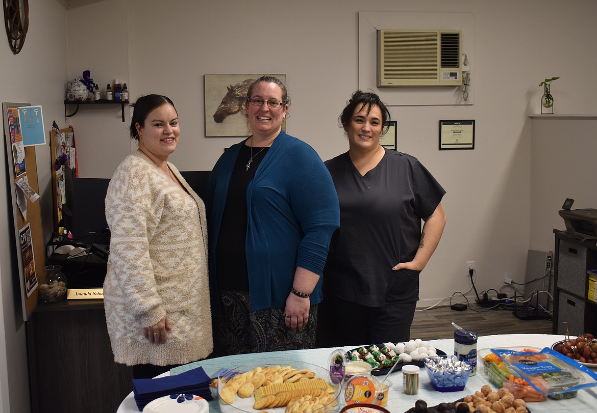 Mandy Schuh, center, owner of Pillar Rock Accounting and Seventh Sense Serenity massage, Schuh’s assistant Esmeralda Sanchez, left, and Christine Villarreal, owner of Christine’s Waxing Room, right, at the grand opening of all three businesses at their new location at 815 W. Third Ave. in Moses Lake.