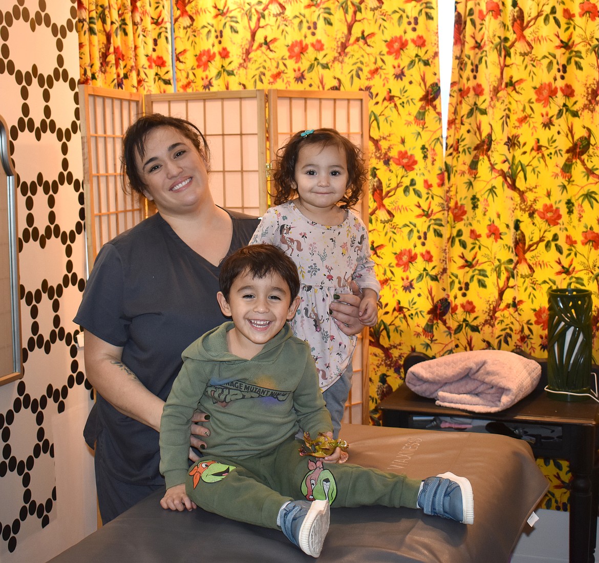 Christine Villarreal, with her children 3-year-old Roman and 2-year-old Belén, in Christine’s Waxing Room.