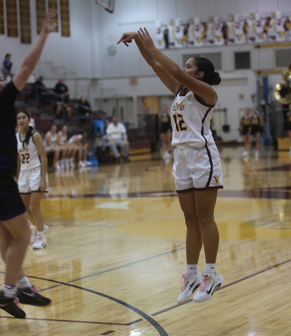 Breanna Bischoff (12) shoots a three-pointer against the Wenatchee Panthers. Bischoff knocked down two three pointers early on to help the Mavericks take the lead.