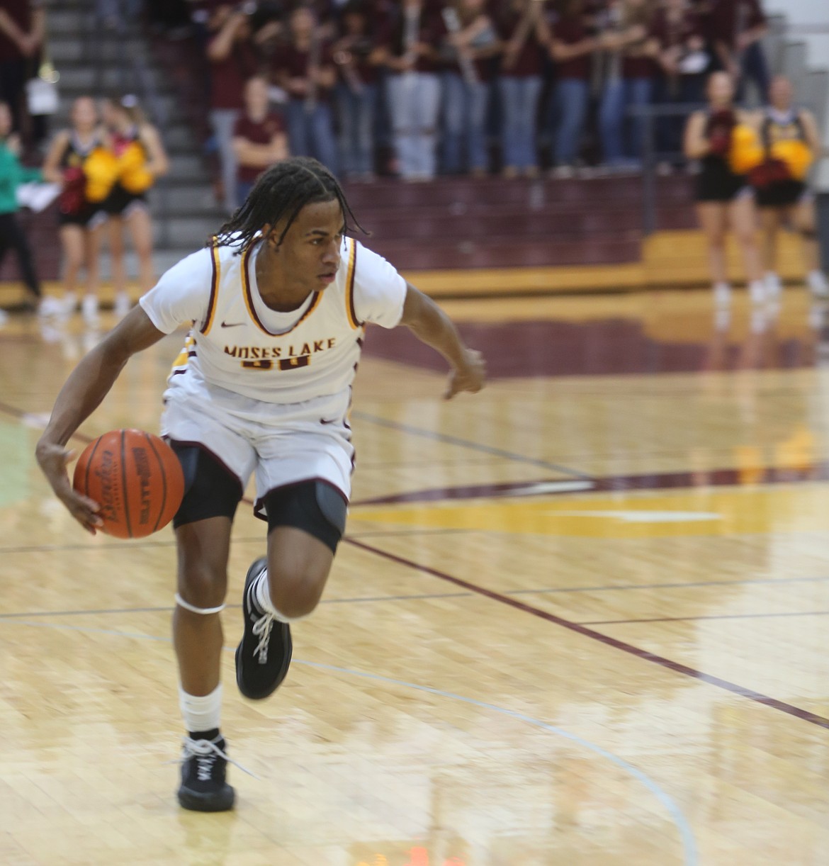 The Mavericks’ Caden Barney (30) dribbles the ball up the court against Wenatchee on Friday. Barney had a one hand dunk that provided a spark to the gymnasium.