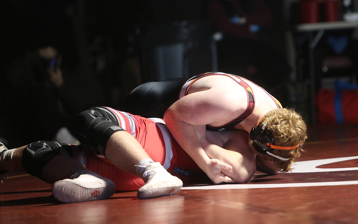 Eli Anderson, top, pins his opponent in a move called the assassin. Head Coach Jose Tanguma said it’s one of Anderson’s favorite moves.
