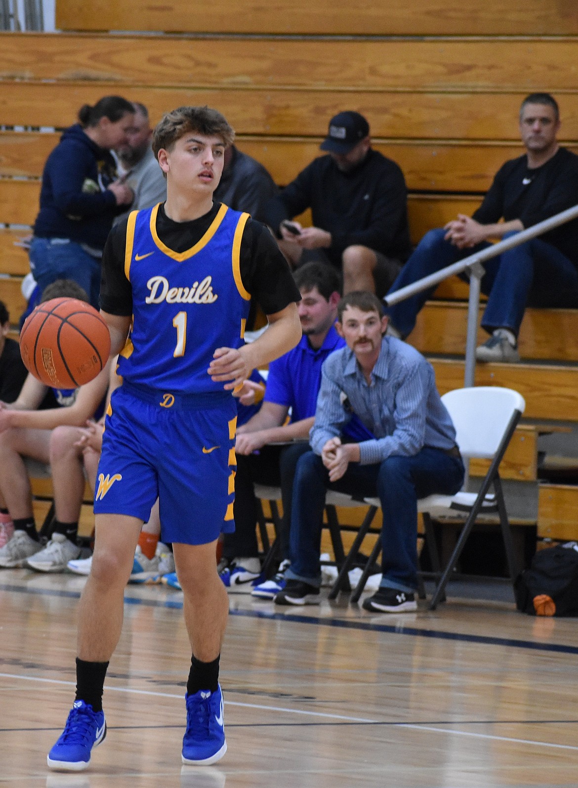 Landon McMillan from the Devils looks toward his teammates near the hoop to try and pass during Thursday’s matchup against the Lions. McMillan led the Devils on offense scoring 11 total points.