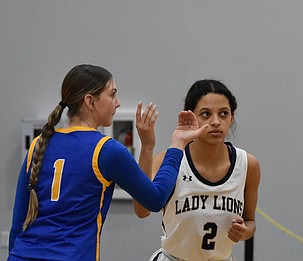 Reece Voss (1) from Wilson Creek and SanTahna Ferguson (2) from MLCA/CCS prepare for the jump ball at Thursday’s tipoff.