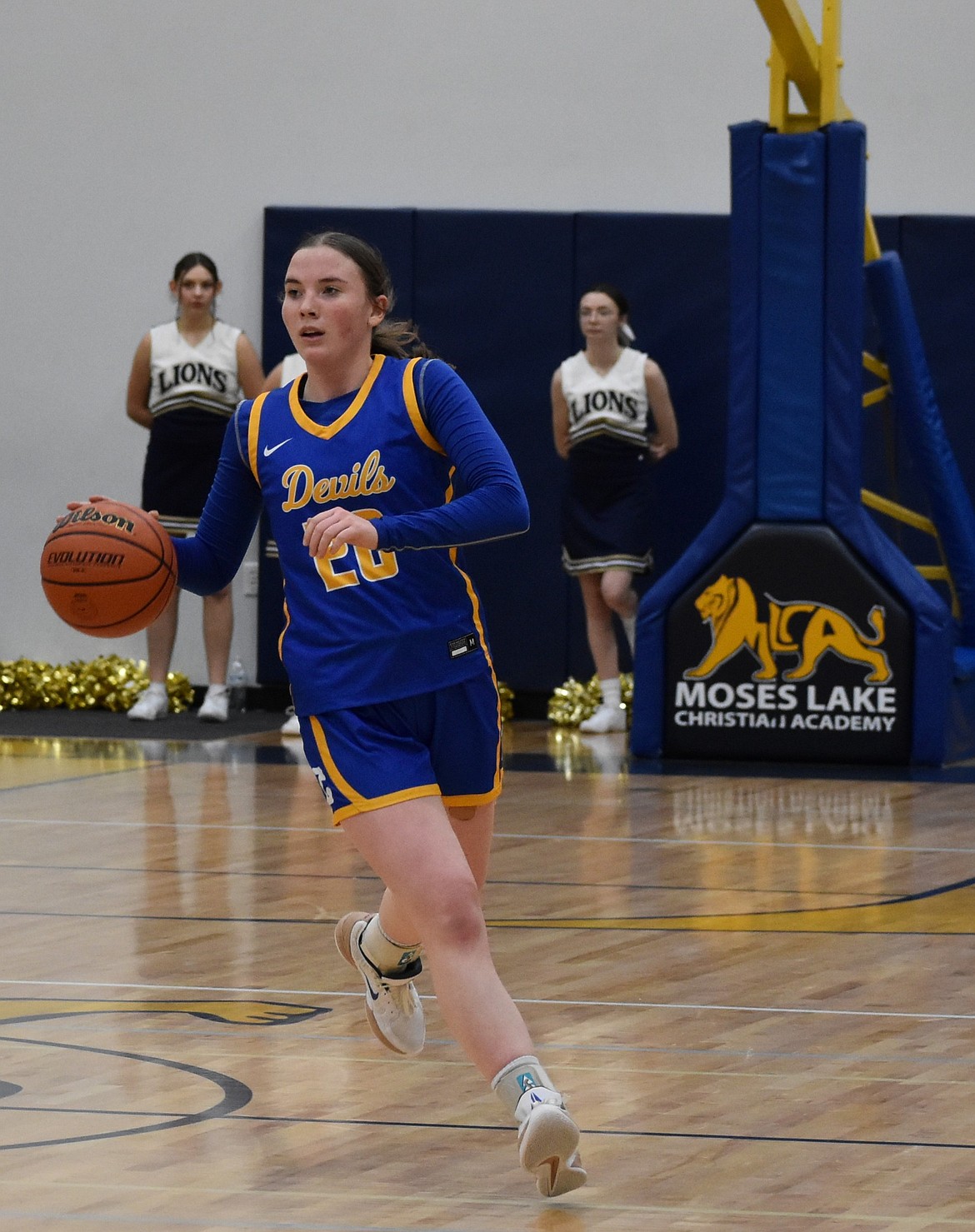 Devils junior Lila Sackmann makes her way down the court looking for an opening to score against the Lions.