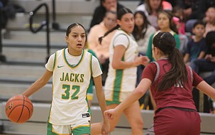 The Jacks’ Chloe Medina (32) dribbles the ball as a Grandview defender steps up to her. The Jacks were defeated 71-29 at home by the Greyhounds Saturday.