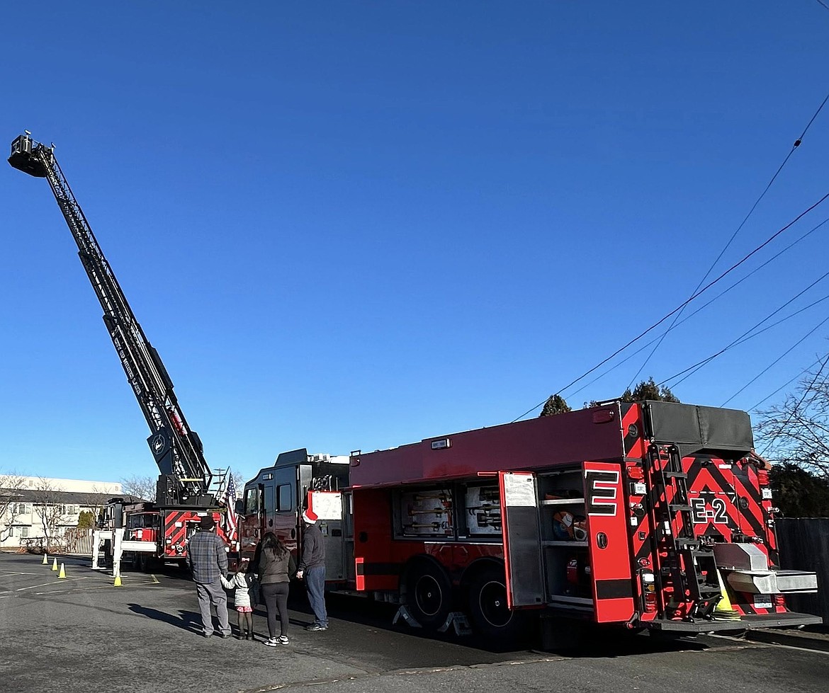 In past years the Moses Lake firefighters have gone out on their trucks to cruise around Moses Lake neighborhoods, but state law forced them to plant themselves in one place to meet the community.