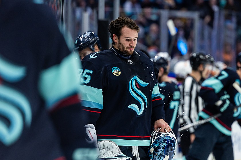 Seattle Kraken goaltender Joey Daccord spits out water during the third period of an NHL hockey game against the Edmonton Oilers, Saturday, Nov. 29, 2025, in Seattle.