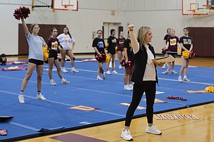 Mavericks Head Coach Mike Carlile, front, guides her team through a routine they have been working on during practice. The Mavericks are the defending state champions eight years in a row and have an opportunity to go for nine straight.