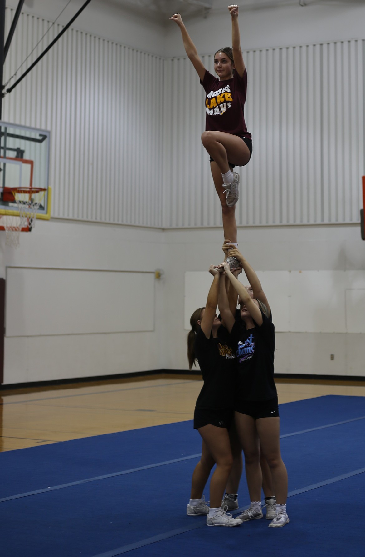 A group of Mavericks cheerleaders work on their stunts at practice. Head Coach Mikey Carlile said their competition season started late because they were supporting the football team during the postseason.