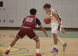 Pierce Bierlink (1) crosses halfcourt as a Grandview defender guards him close. The Jacks were defeated 67-47 at home by the Grandview Greyhounds Saturday.