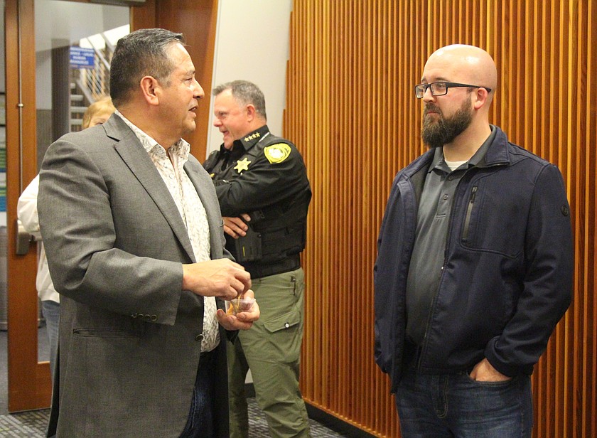 State Representative Alex Ybarra, right, and Moses Lake City Council member Don Myers, left, discuss issues of importance to the city.