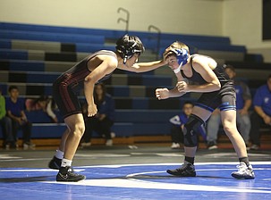 Jesus Cruz, left, places his hand on Justice Cafferty, right, as he looks for an opportunity to attack. The Warden Cougars defeated the Wahluke Warriors 54-18 in their duel Tuesday.