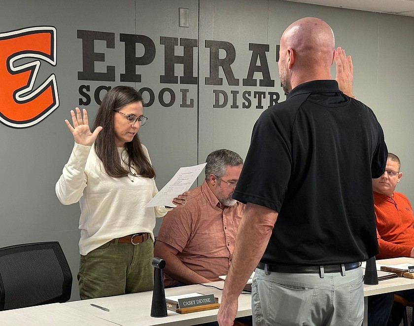 Ephrata Superintendent Ken Murray, right, swore in Ephrata School Board Member Casey Devine, left, at the Monday regular school board meeting. Three board members were sworn in; all ran unopposed and are returning members of the board.