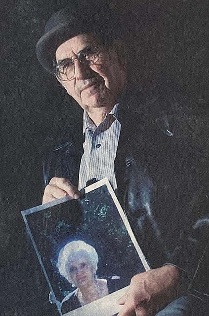 Larry Hanley, who co-founded Christmas for All, holds a photo of his late wife, Mae, in 2004.