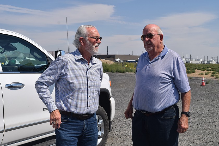 Congressman Dan Newhouse, left, talks with Port of Quincy Commissioner Patric Connelly during a visit to Quincy in August. Newhouse announced Wednesday he would not seek another term in the House.