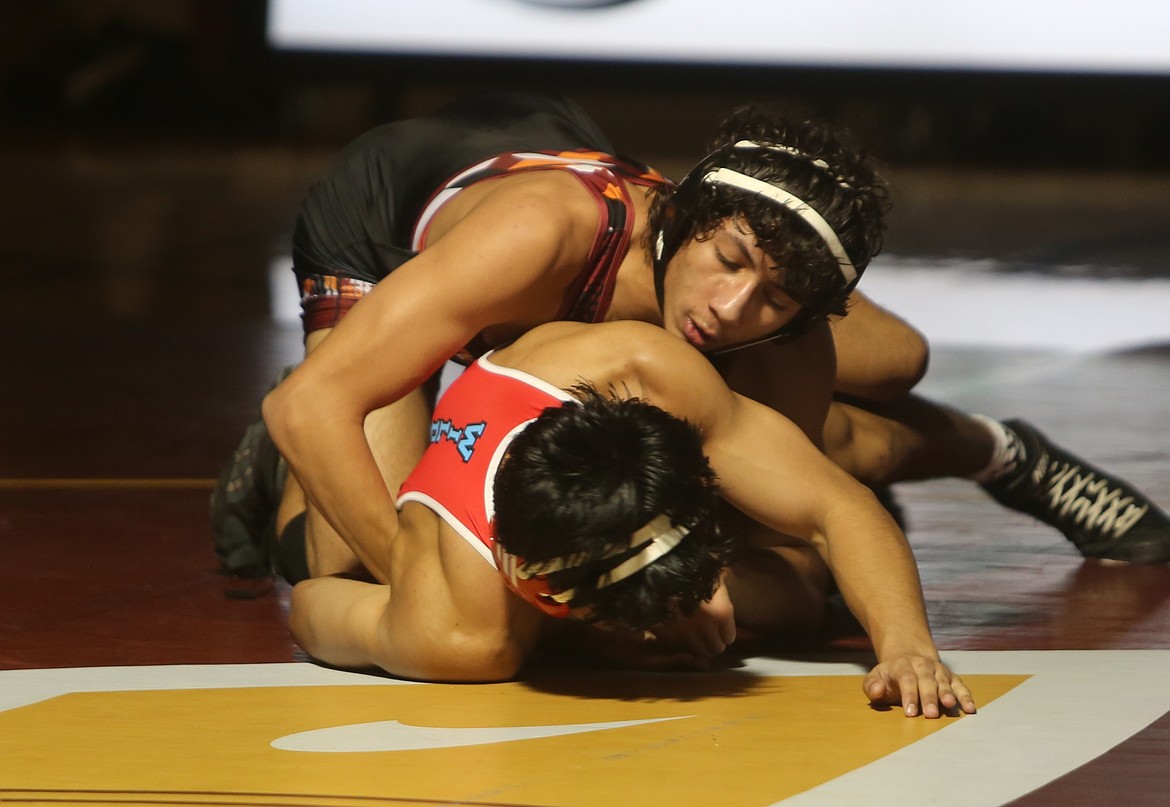 The Mavs’ Duane Zamora, top, controls his opponent on the mat during their match against Eastmont. Zamora was victorious via a 5-3 decision.