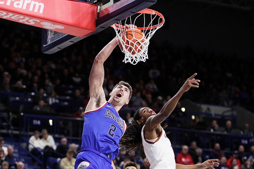 Gonzaga guard Steele Venters (2) dunks while pressured by Campbell guard Jeremiah Johnson during the second half of an NCAA college basketball game, Wednesday, Dec. 17, 2025, in Spokane, Wash.
