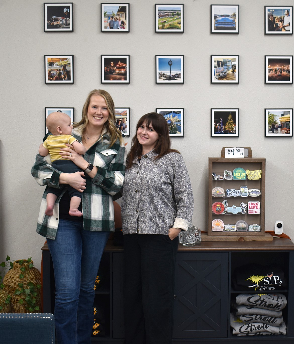 Mallory Miller, left, and Sarah Page of the Downtown Moses Lake Association in the organization’s new office on South Division Street. Page came on board as the DMLA’s events coordinator in July, and the little fellow in Miller’s arms came along in August.