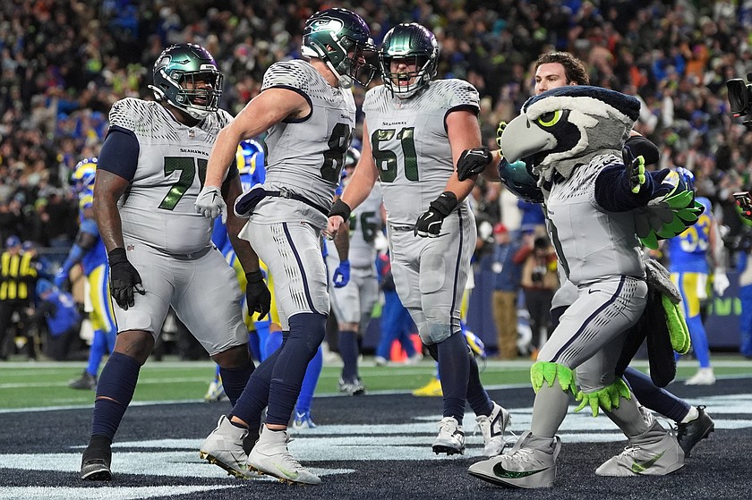 Seattle Seahawks tight end Eric Saubert, second from left, celebrates after making a two-point conversion during overtime in an NFL football game against the Los Angeles Rams, Thursday, Dec. 18, 2025, in Seattle.