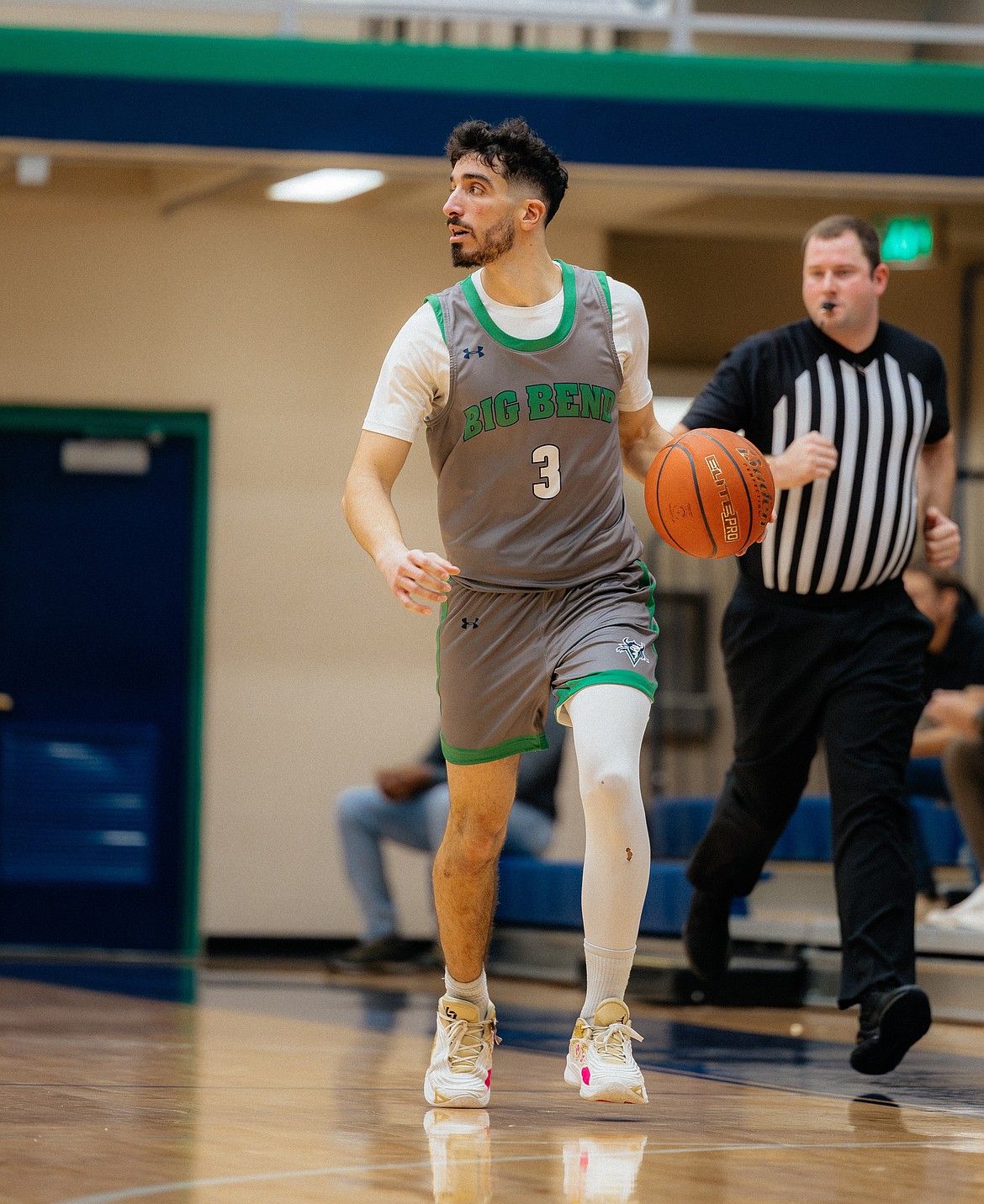 Ori Mizrahi from BBCC dribbles the ball along the side of the court waiting for an opening to pass to a teammate or make a move on the basket.