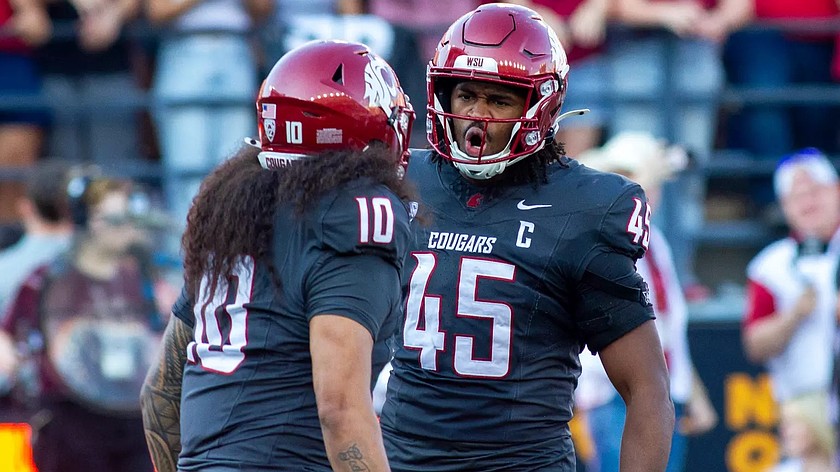 Cougars defensive ends Buddha Peleti and Raam Stevenson celebrate after making a stop during a previous game this season. The Cougars are heading to Boise to play against Utah State in the Famous Idaho Potato Bowl.