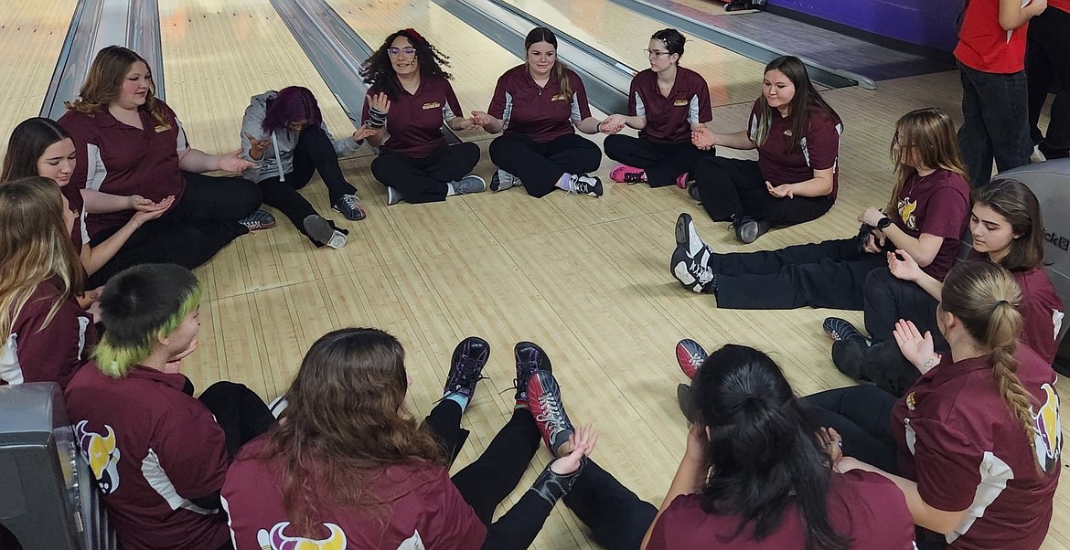 The Mavs team sits together in a circle at Lake Bowl prior to starting their competition at a previous meet this season. Head Coach Dan Stevenson said this year’s team has a very strong bond which has helped with their success.