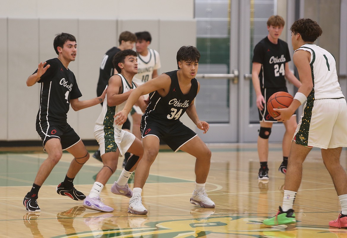 Luis Farias Villanueva (34) and Syrus Peppinger (4) jam Erick Zepeda (3) while the Jacks were on offense.