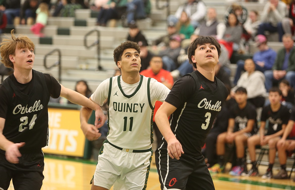 Juan Tovar (3) and Josh Lawson (24) box out Nash Bierlink (11) as they try to rebound the ball.