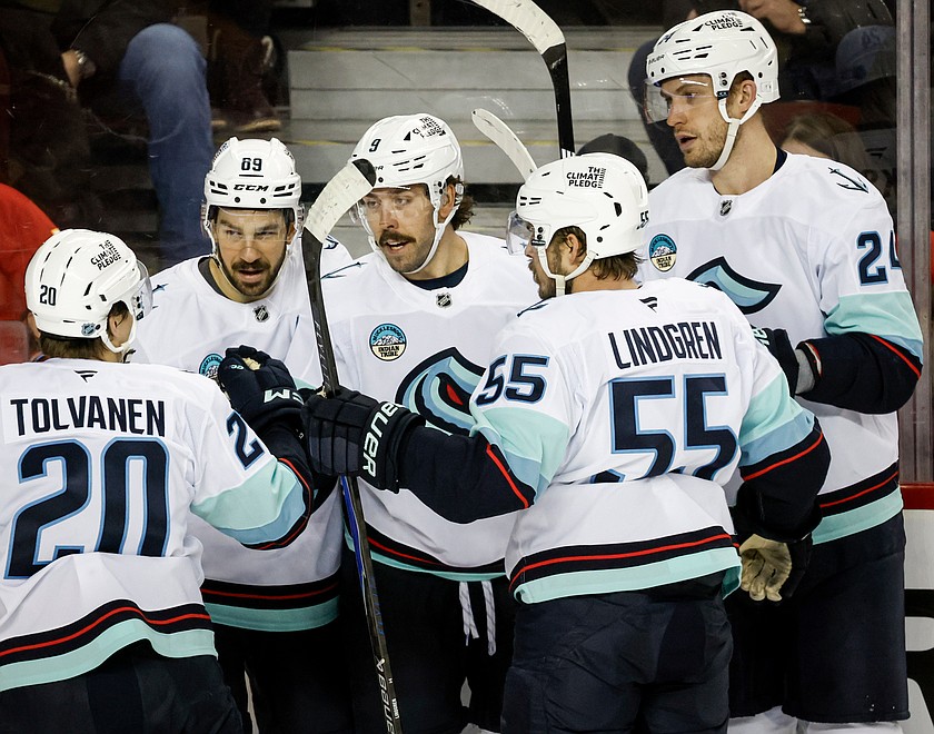 Seattle Kraken's Chandler Stephenson, centre, celebrates his goal with teammates during the second period of an NHL hockey game against the Calgary Flames, in Calgary, Alberta, Thursday, Dec. 18, 2025