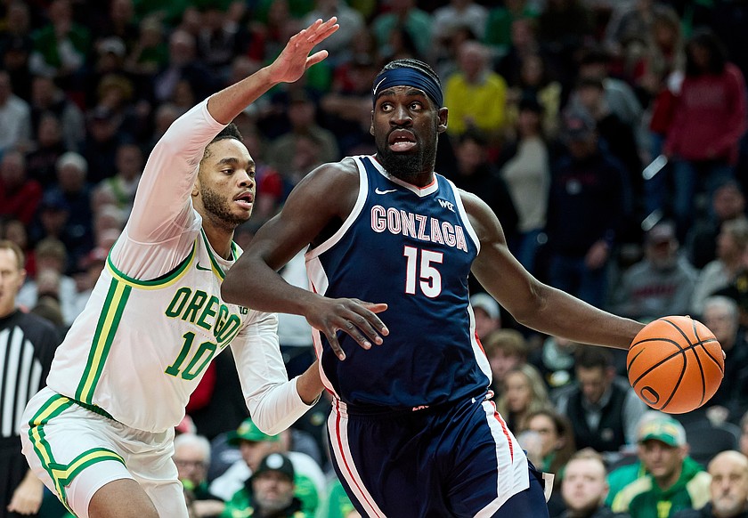 Gonzaga forward Graham Ike, right, dribbles past Oregon forward Kwame Evans Jr. during the first half of an NCAA college basketball game in Portland, Ore., Sunday, Dec. 21, 2025.