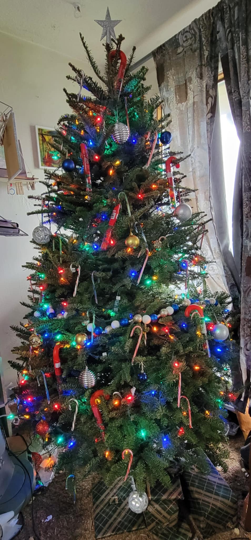 Joel Martin, a staff writer at the Columbia Basin Herald, and his family’s tree celebrates candy canes of all sorts and has a few presents already position for Christmas morning.
