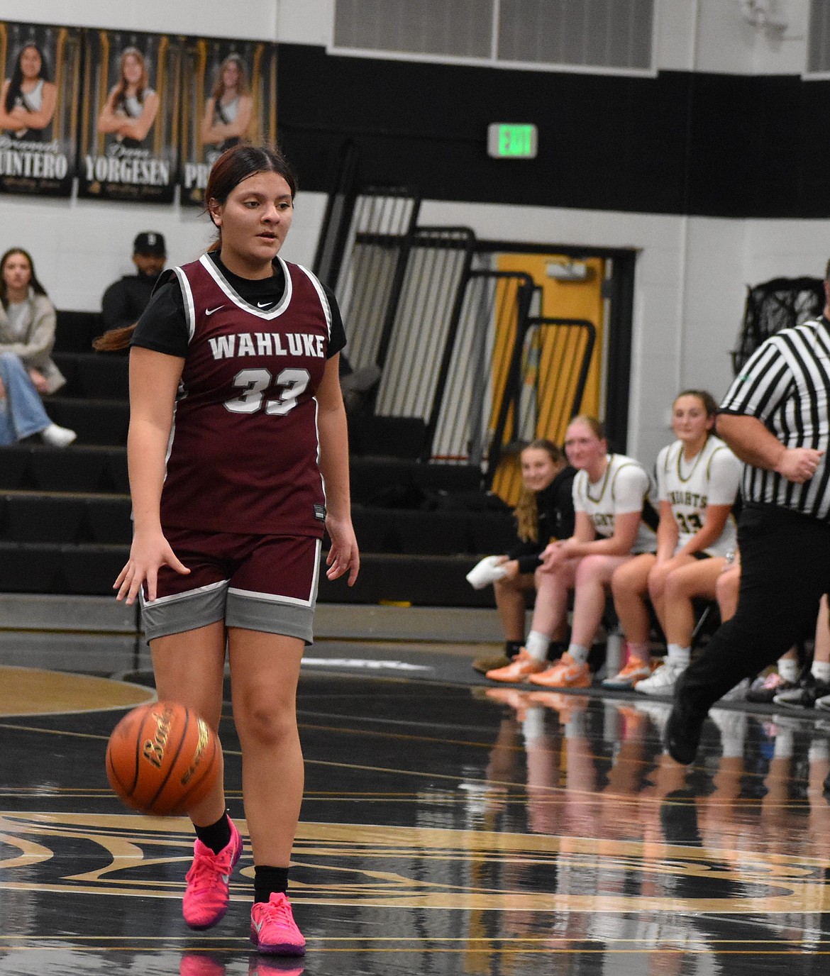 Analina Martinez, a sophomore for the Warriors, takes the ball toward the net while keeping her eyes on the opposing Knights defenders.