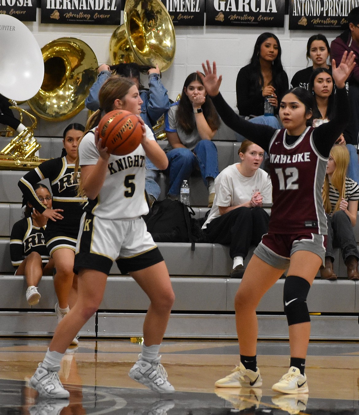 Maggie Frank, a Royal junior, looks to pass the ball with Mia Morales, a Wahluke sophomore,